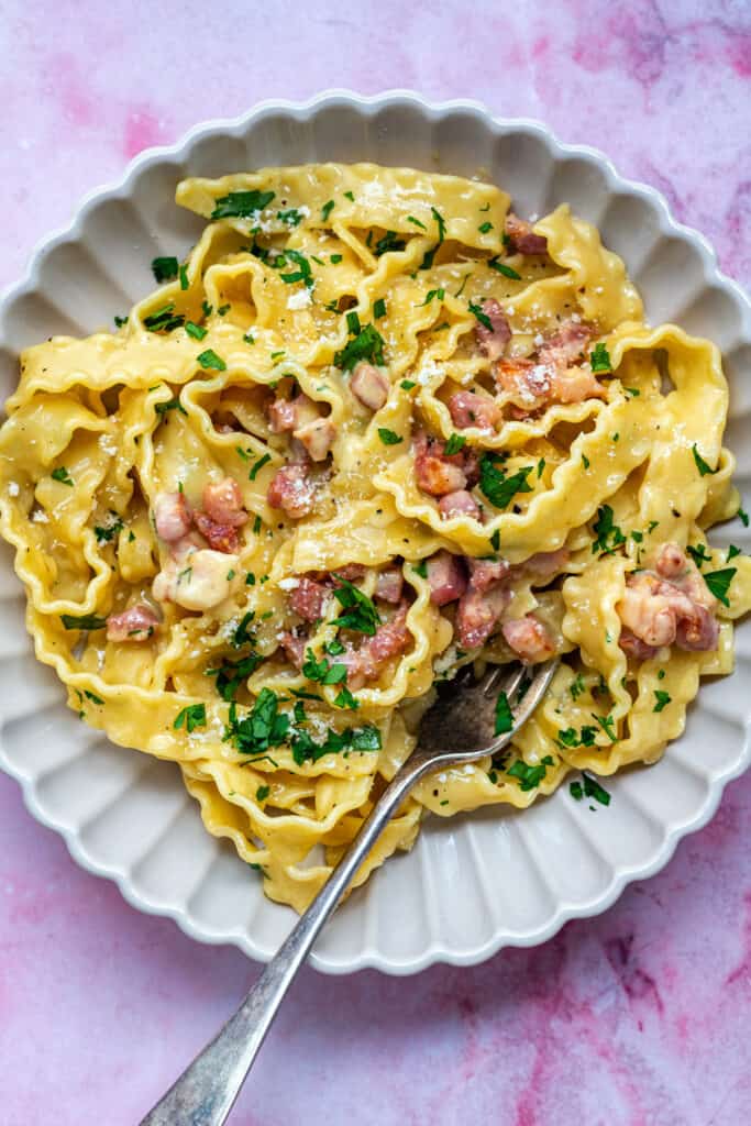 bowl of pasta with bacon and cream sauce