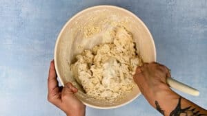 Shaggy bread dough in a mixing bowl