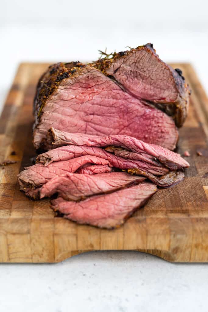 Topside of Beef roasted and sliced on a cutting board