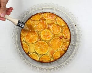 brushing clementine cake with jam