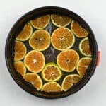 Cake tin lined with citrus slices lining the bottom