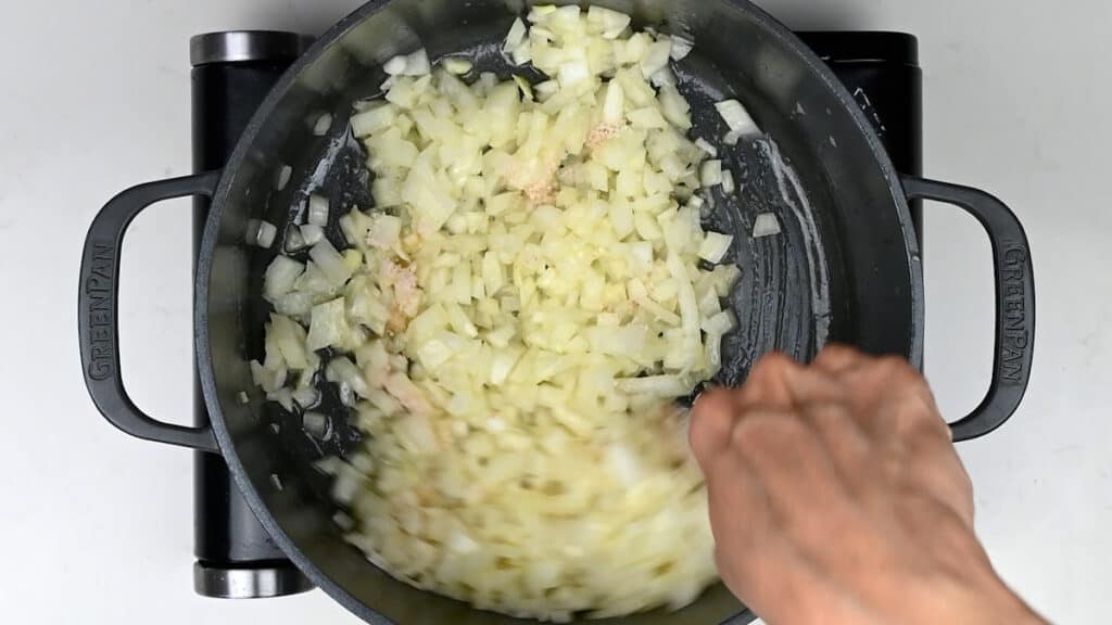 cooking diced onions in a pot