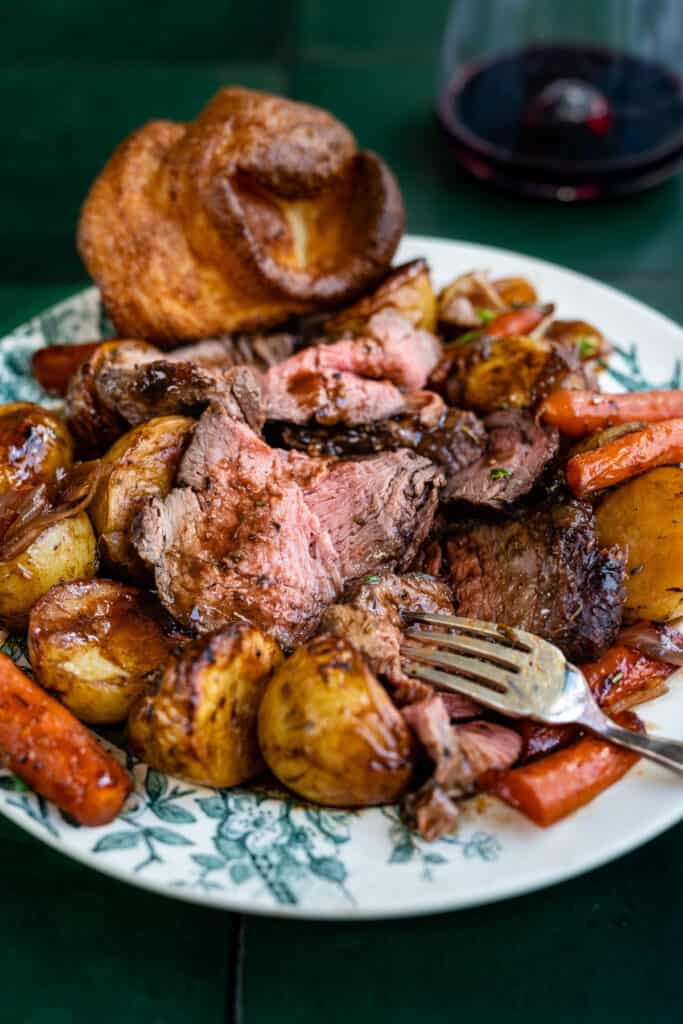 Beef pot roast on a plate with potatoes carrots and gravy