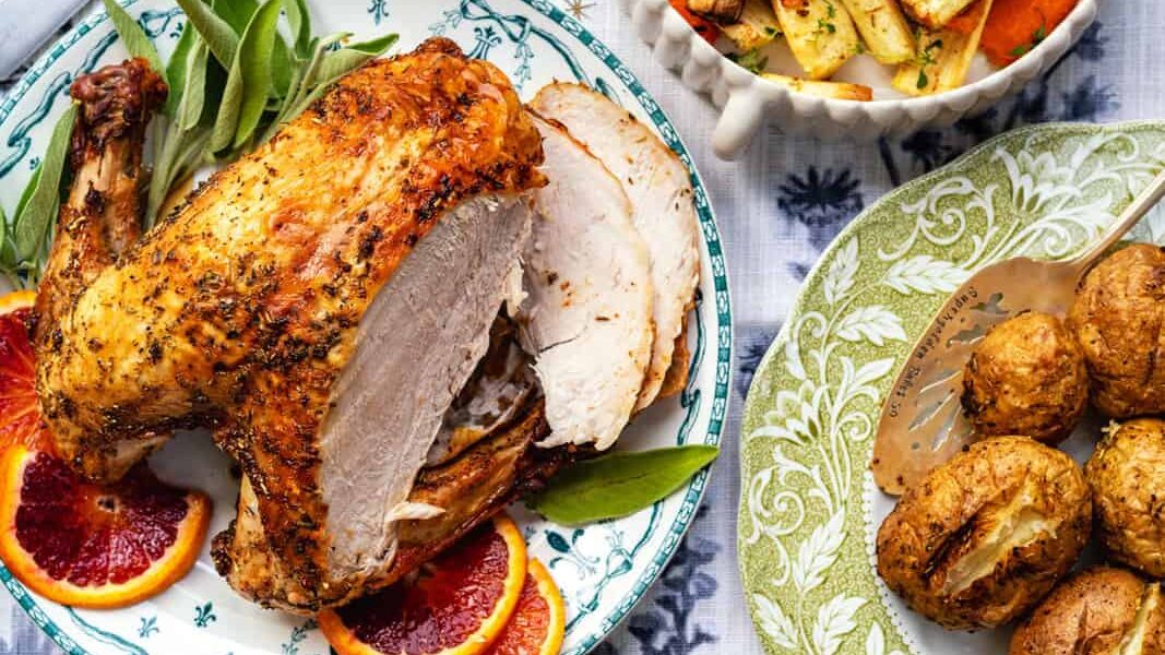 Table set with roast turkey, potatoes, gravy and vegetables