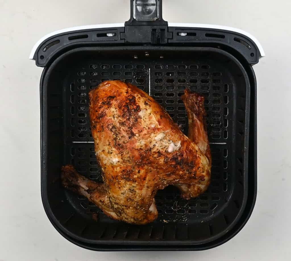 Cooked turkey in an air fryer basket