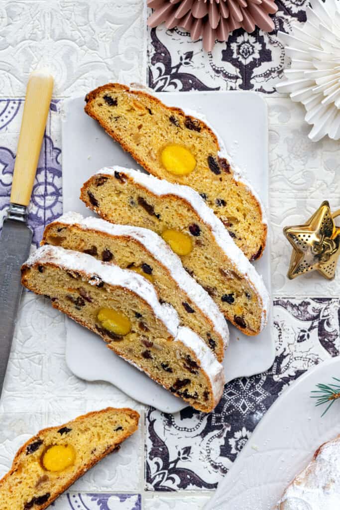German Stollen bread with marzipan center, sliced, on a board