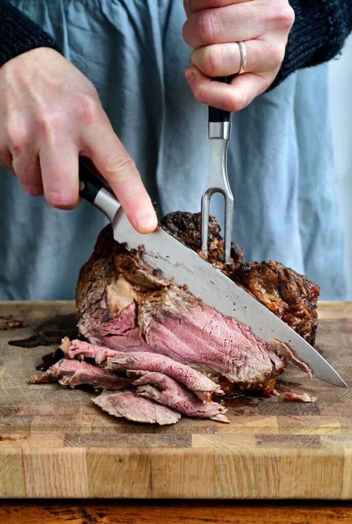 Carving a boneless prime rib joint on a cutting board