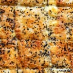 Close up on tyropita topped with sesame seeds