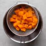 cooked sweet potatoes in a sieve