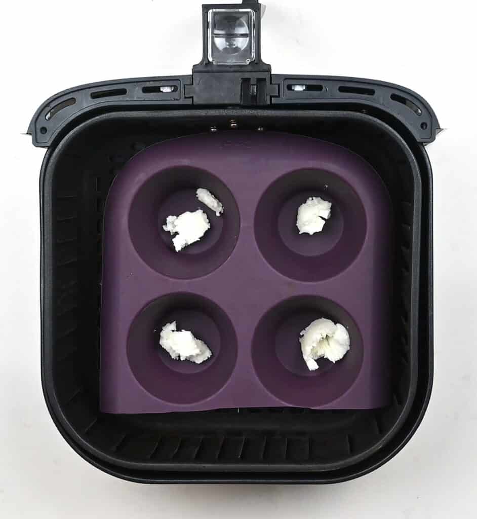 Silicone muffin tin in an air fryer basket
