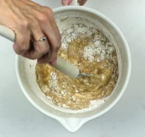 Folding flour into banana bread batter