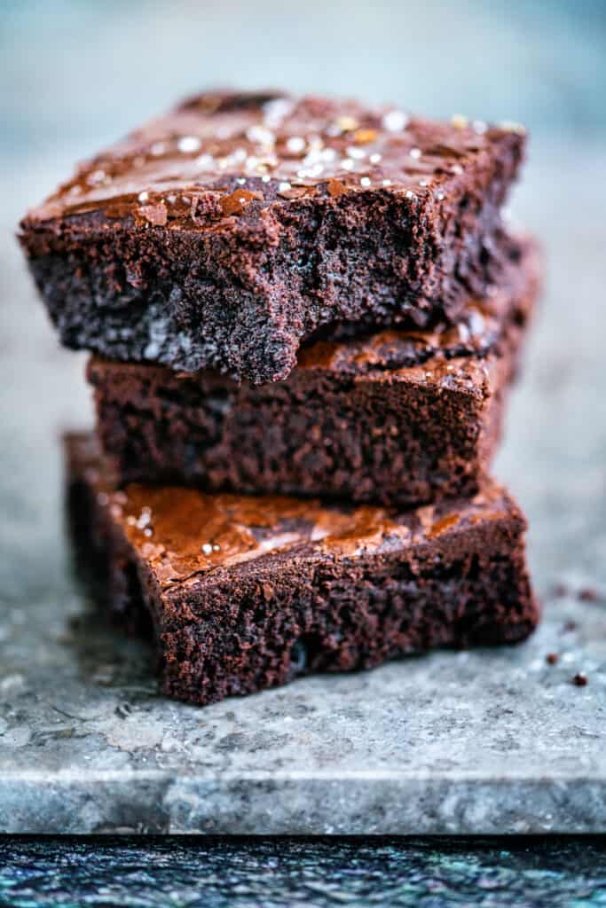 Air fryer brownies stacked one with a bite taken out