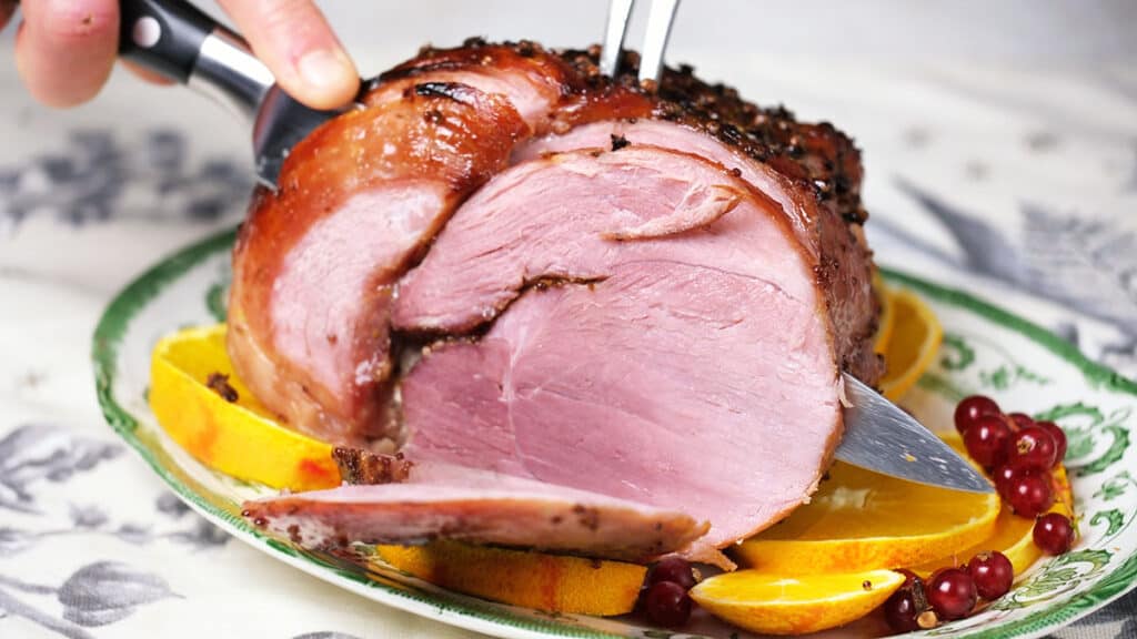 slicing glazed ham cooked in an air fryer