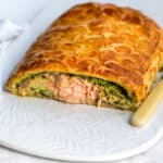 Salmon Wellington with slice cut to show the filling