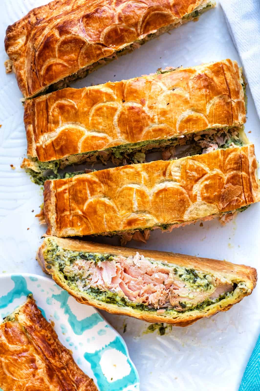 Salmon Wellington sliced on a ceramic board
