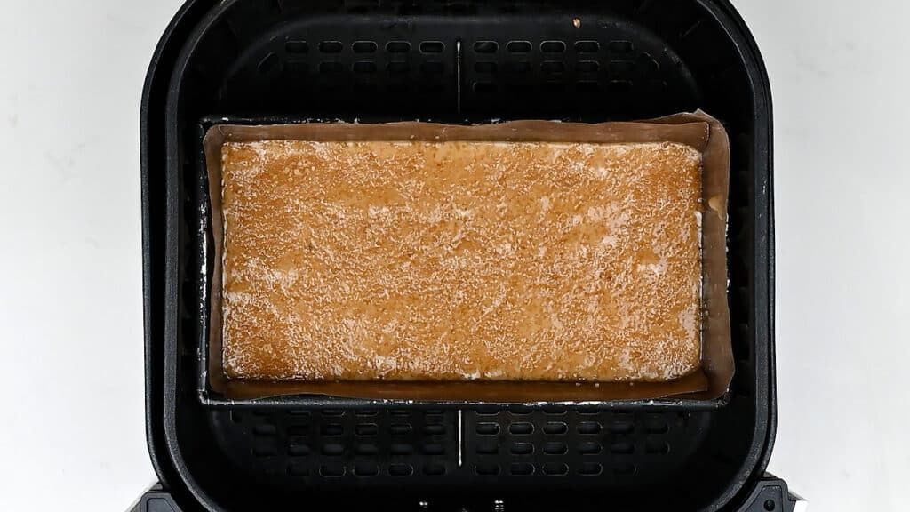 Loaf tin with banana bread batter in an air dryer basket