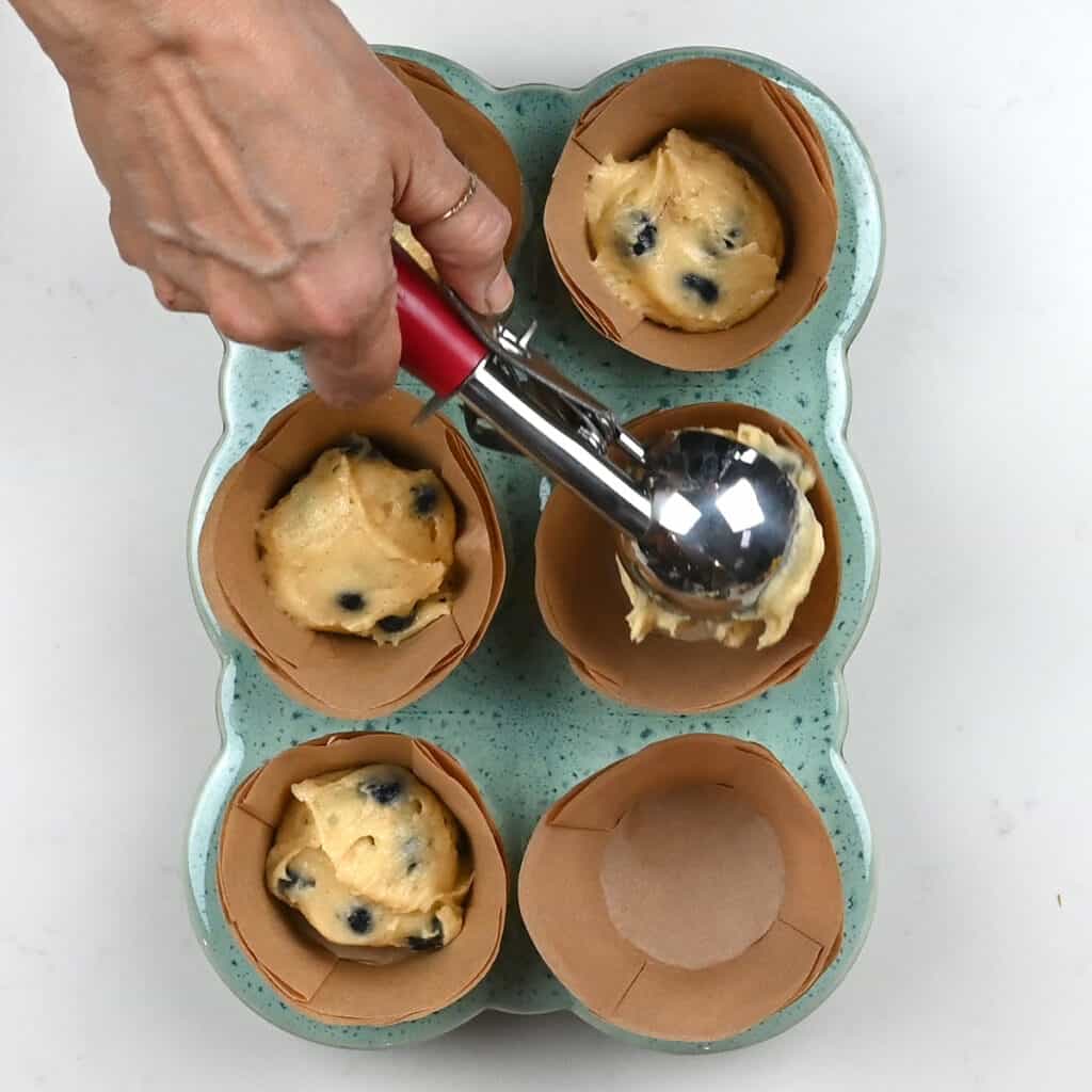 Adding batter into muffin cases