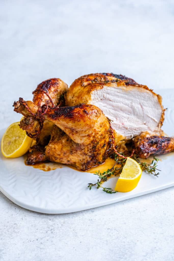 Air fryer whole chicken rotisserie style with slice cut