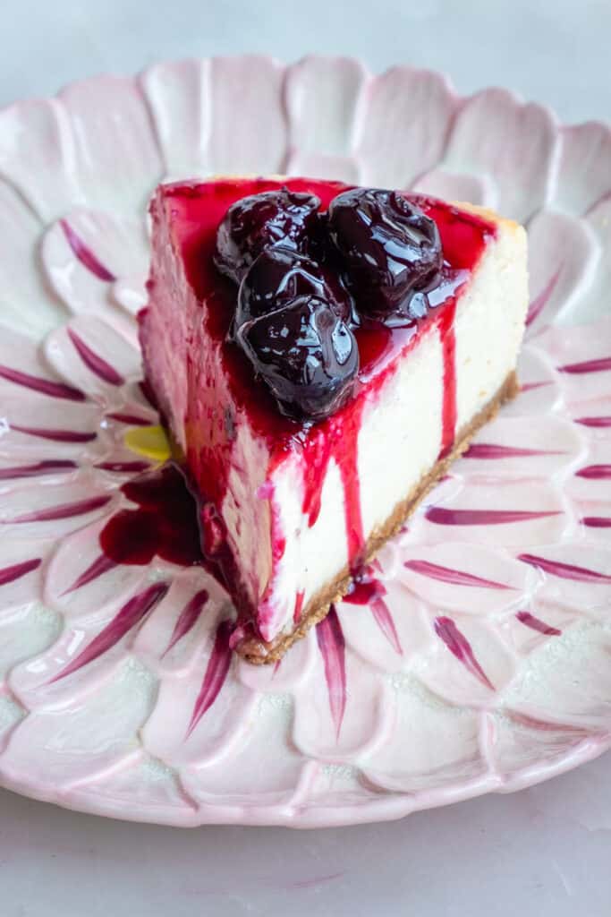 slice of baked cheesecake on a pink plate