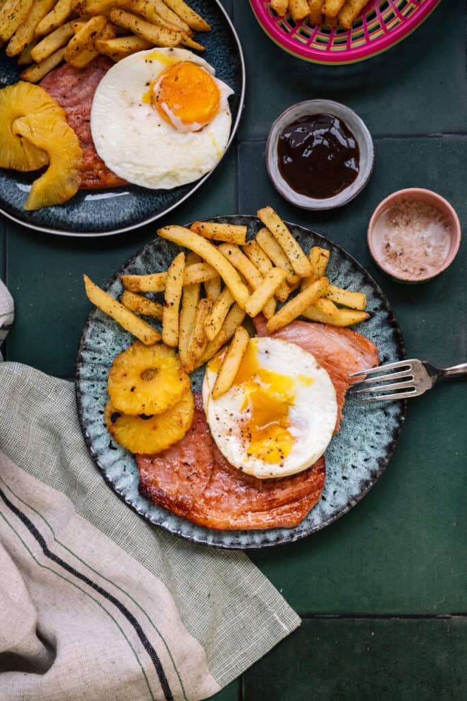Plate with air fryer gammon steak, pineapple rings, egg and chips