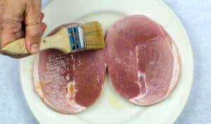 brushing ham steaks with a sweet glaze
