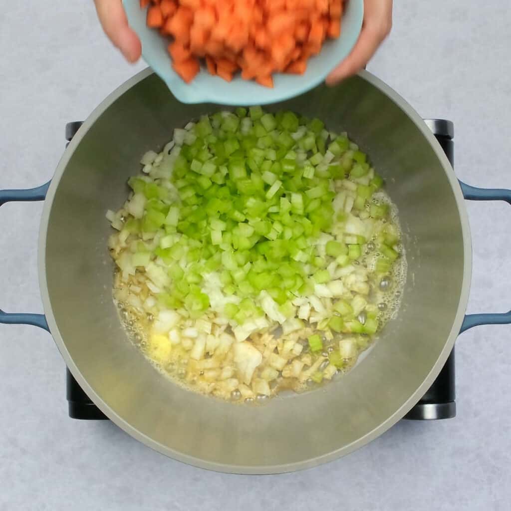 Cooking onions, celery and carrots in a large pot