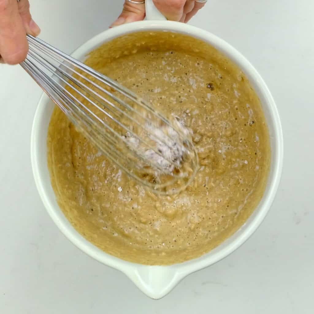 stirring batter for Guinness Bread in a mixing bowl using balloon whisk