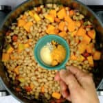 Cooking orzo vegetable soup in a pot