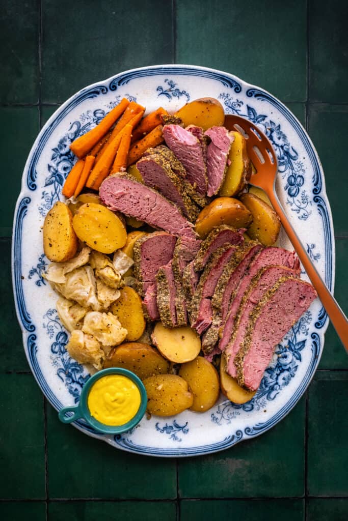 Platter with sliced corned beef, cabbage, carrots and potatoes
