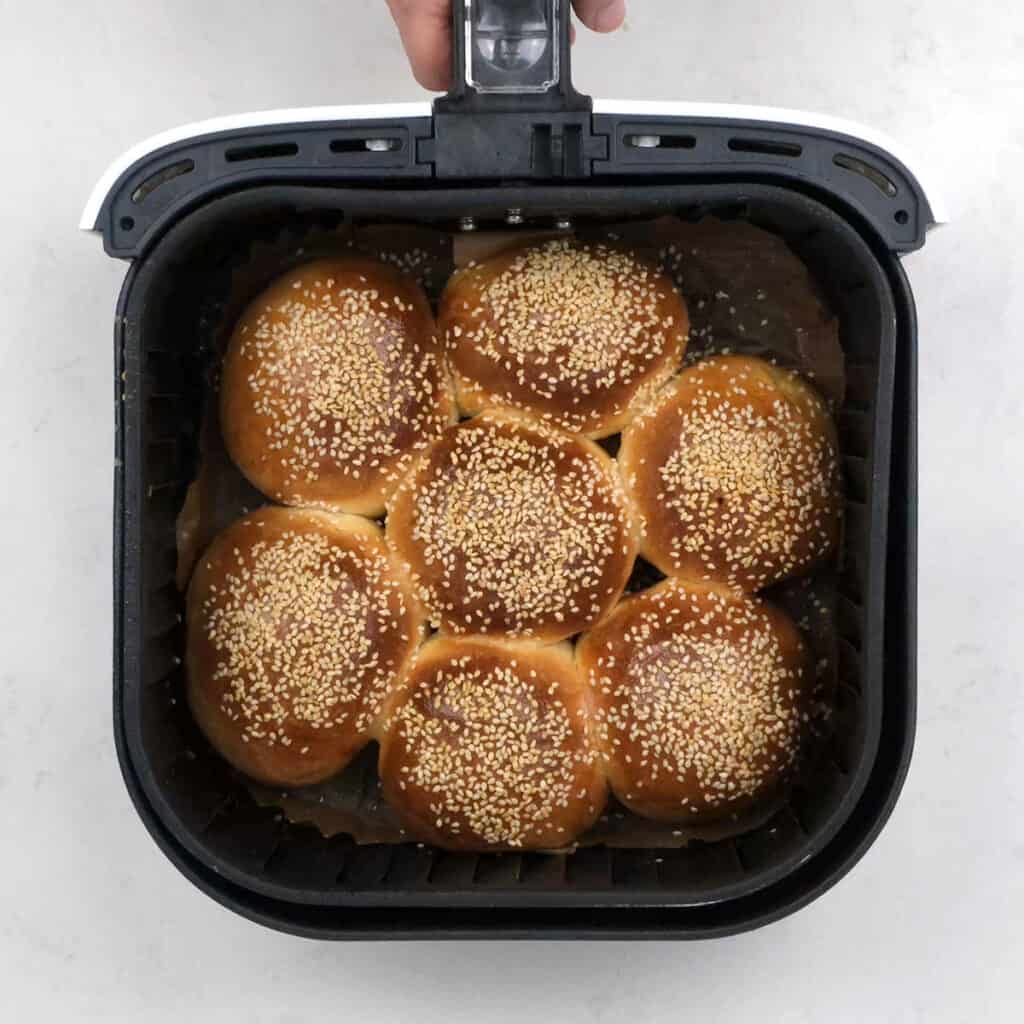 baked bread rolls in an air fryer basket