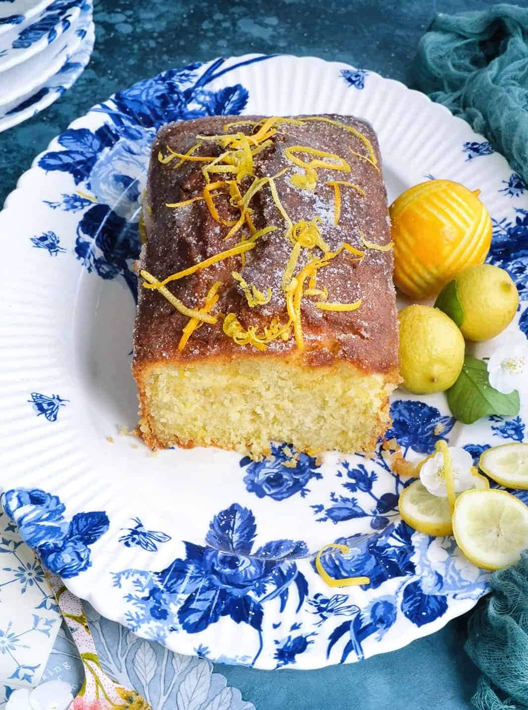 sliced lemon drizzle loaf on a patterned platter