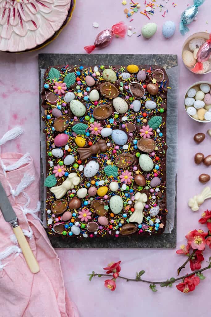 Easter tray bake cake with chocolate frosting and Easter candy decorations 