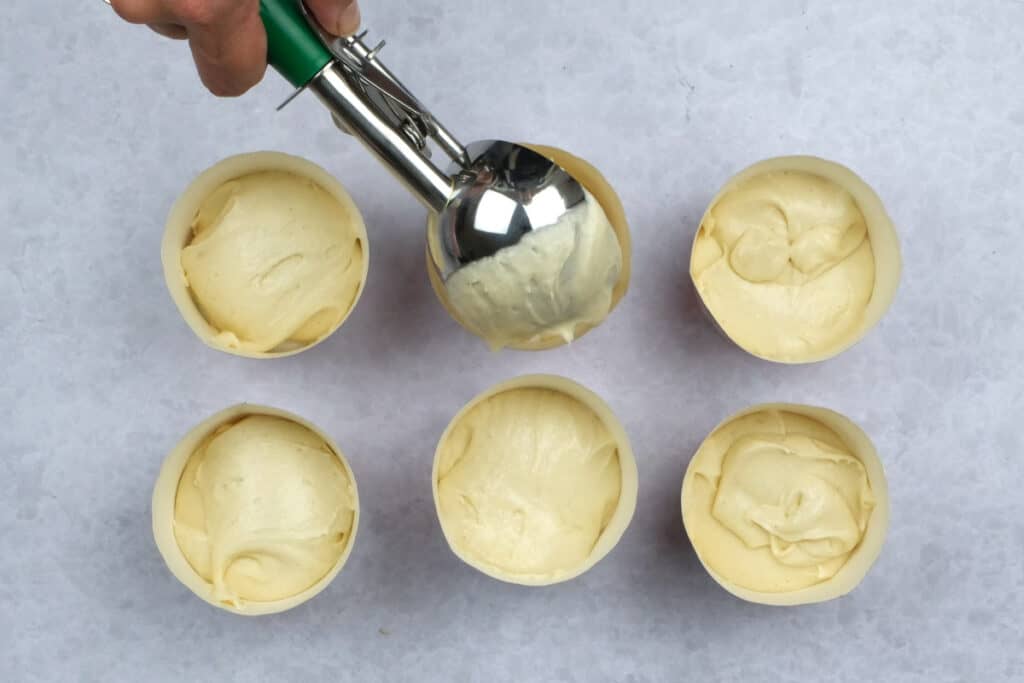 adding batter to cupcake cases using a cookie scoop