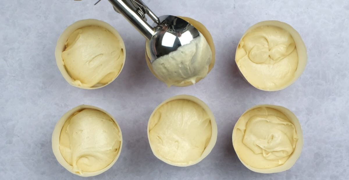 adding batter to cupcake cases using a cookie scoop
