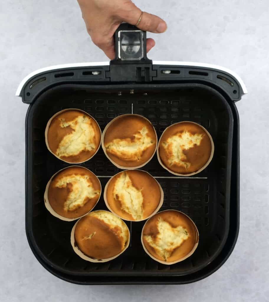 Vanilla cupcakes in an air fryer basket