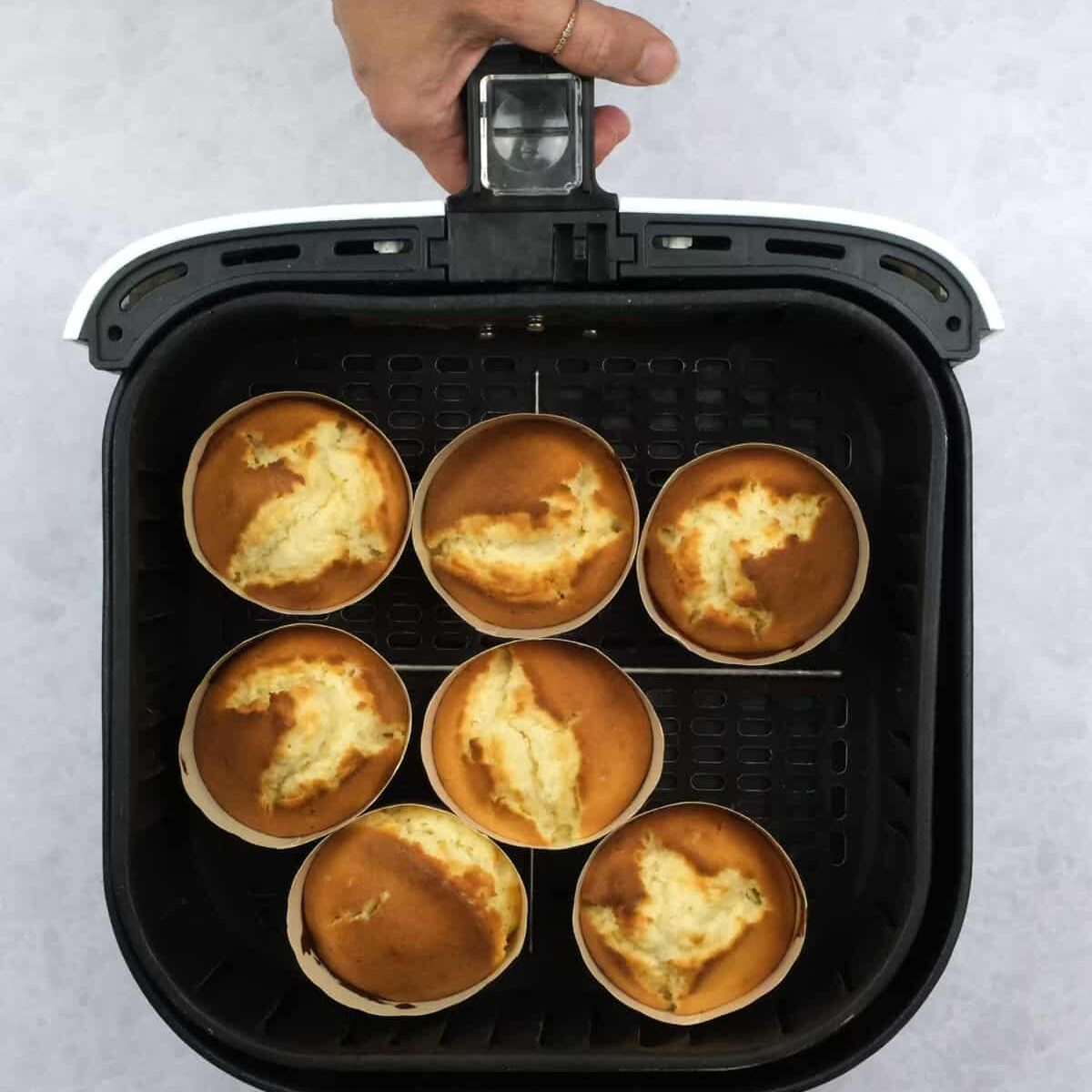 Vanilla cupcakes in an air fryer basket