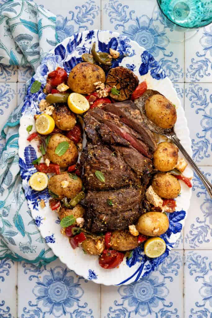 Greek Lamb Kleftiko on a platter with vegetables and feta