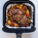 Lamb Kleftiko cooked in an air fryer with potatoes, peppers and tomatoes