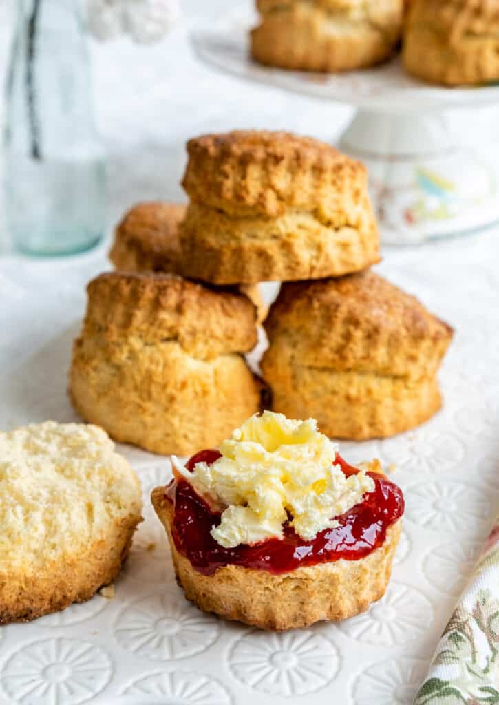 Scones, one split and served with clotted cream and ja,
