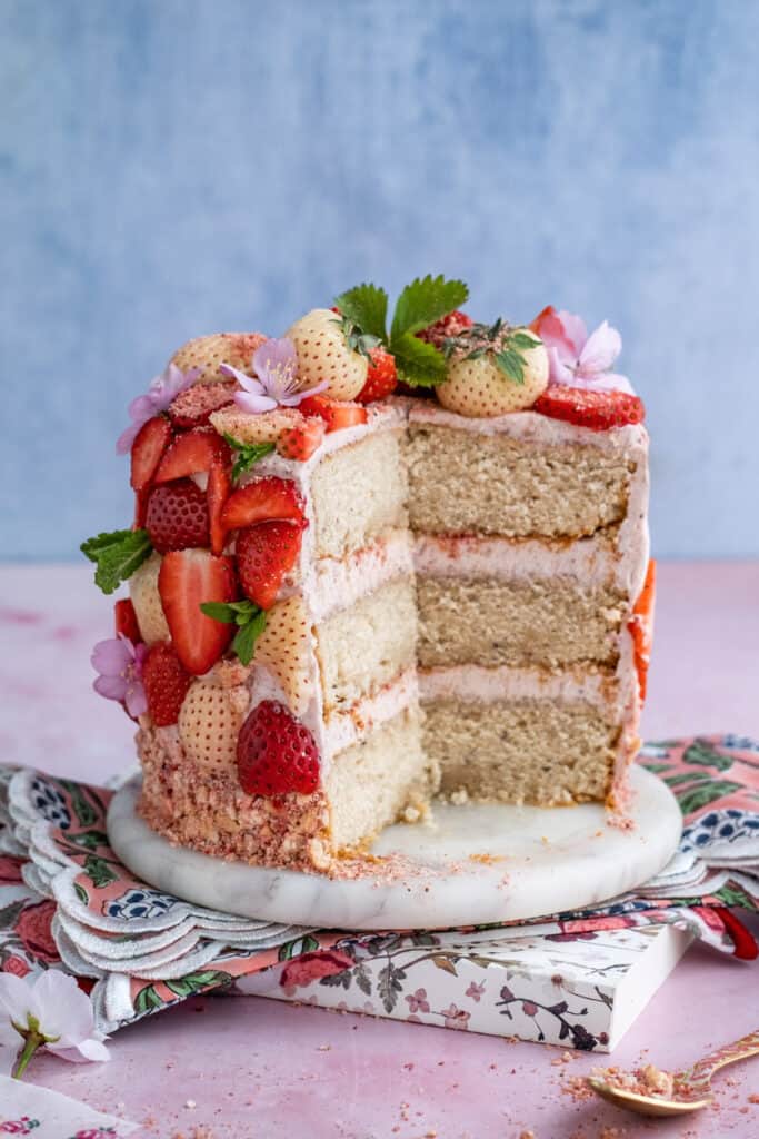Strawberry crunch cake with large slice cut out