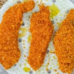 Chicken tenders with crunchy cornflake coating in an air fryer rack