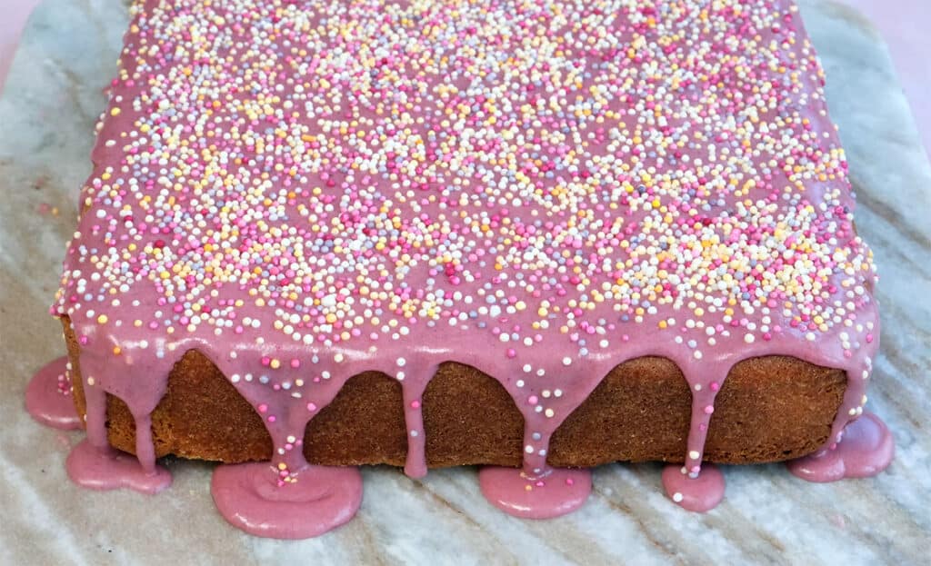School cake with pink glaze and sprinkles