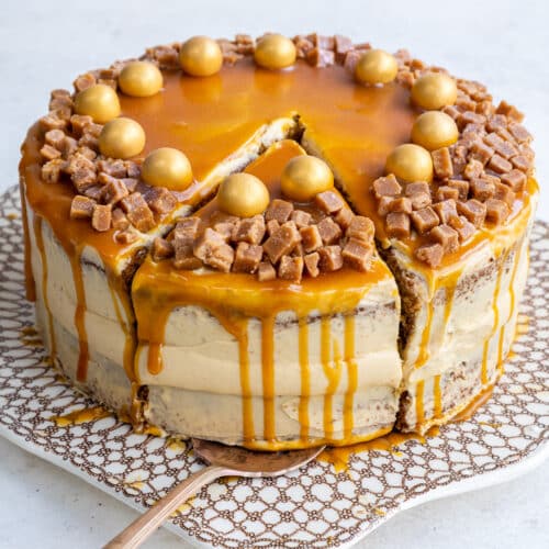 Mary Berry Salted Caramel cake on a patterned cake plate, one slice cut