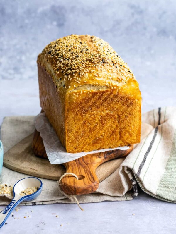 Sourdough Loaf Bread topped with sesame seeds on a wooden board