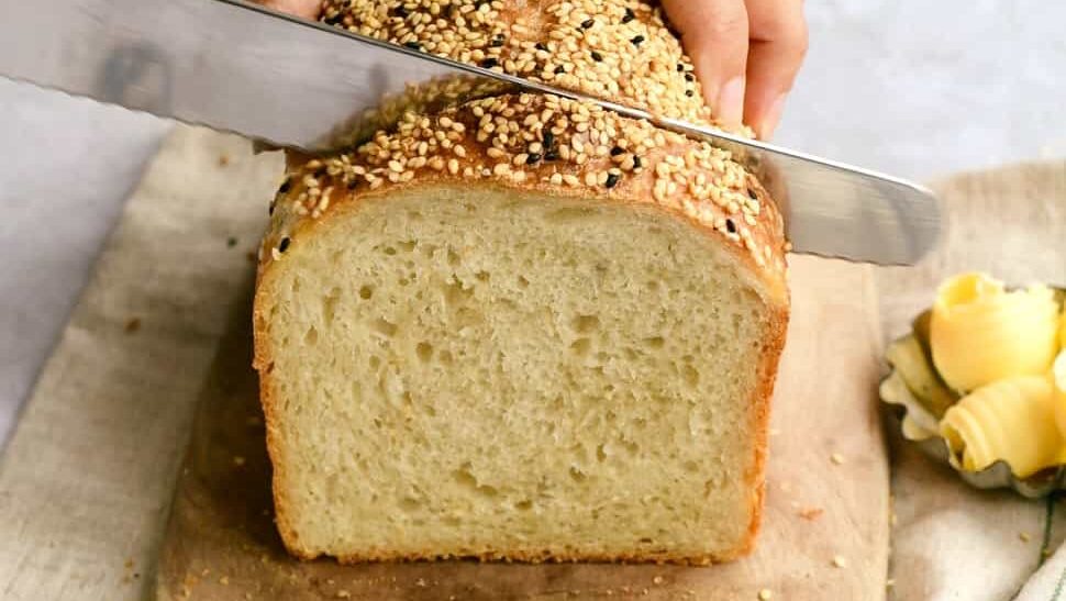 Slicing loaf of white bread