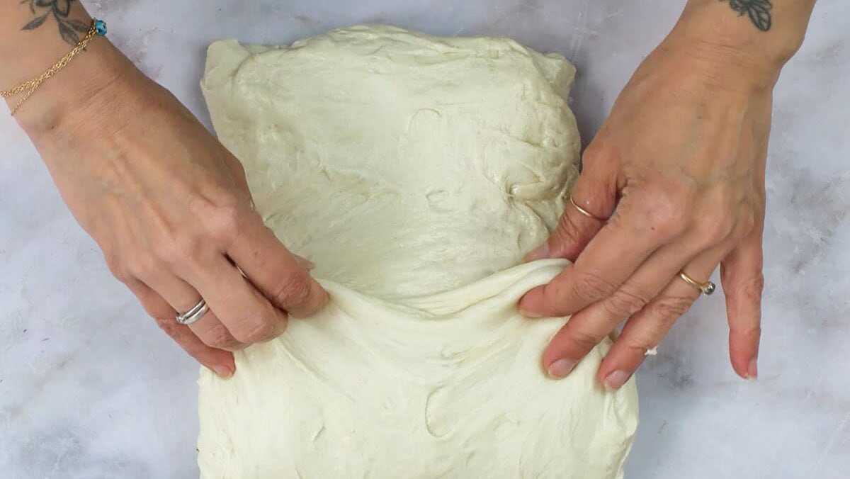 doing a letter fold on sourdough bread dough