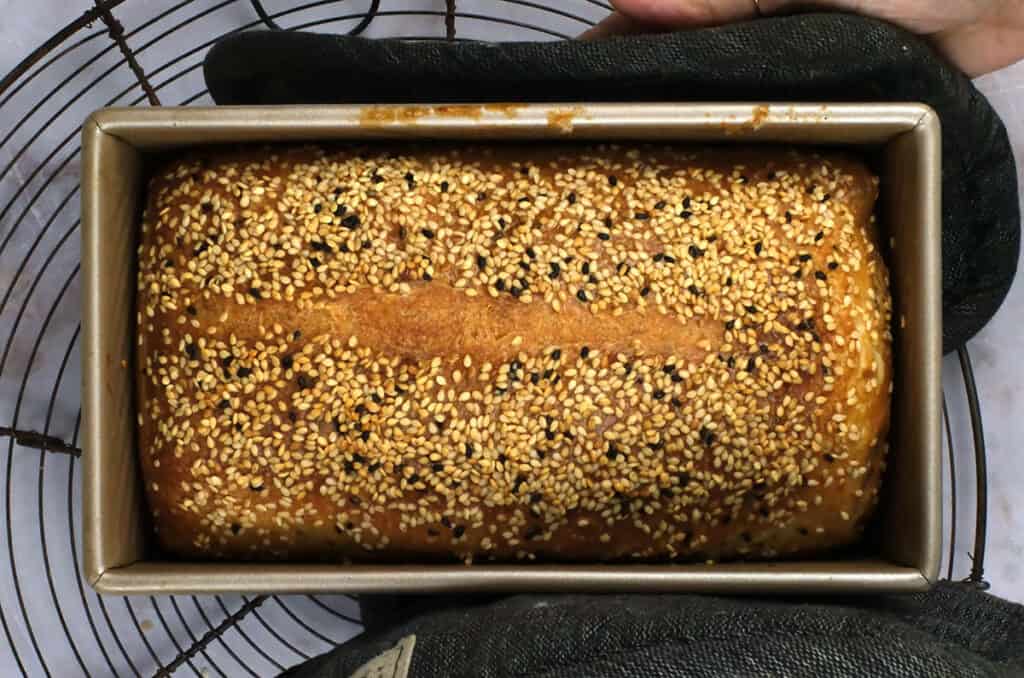 baked sourdough in loaf pan