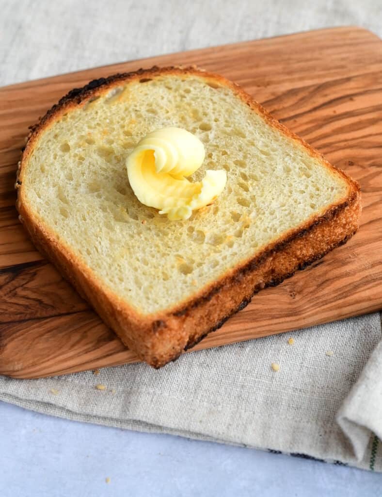 Toasted slice of sourdough bread topped with butter