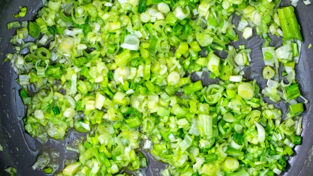cooking spring onions, leeks and garlic in a pan