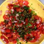 chopped tomatoes, shallots, capers, parsley in a bowl